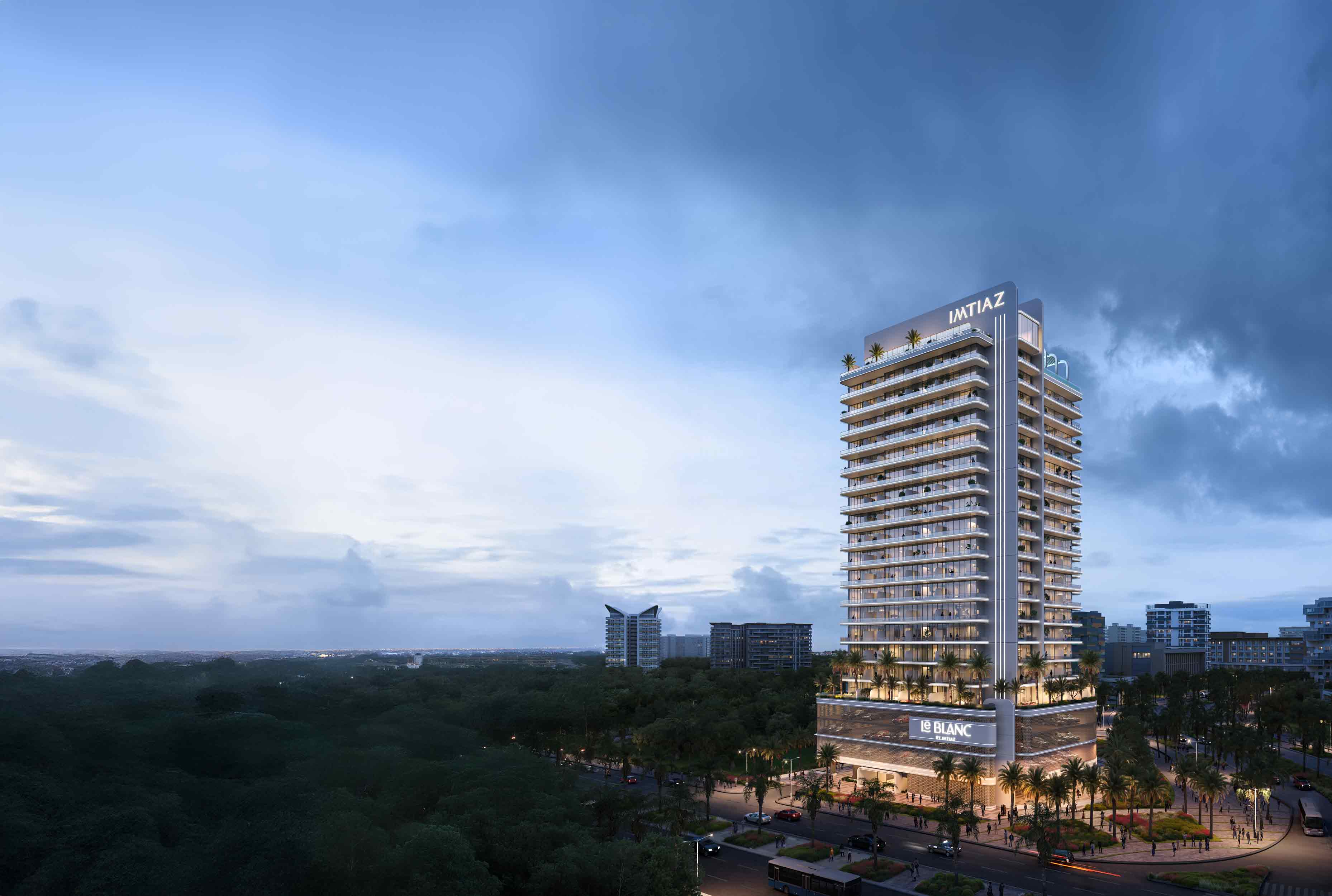 Le Blanc Modern high-rise building surrounded by greenery under a cloudy sky, showcasing contemporary architecture and landscaping.
